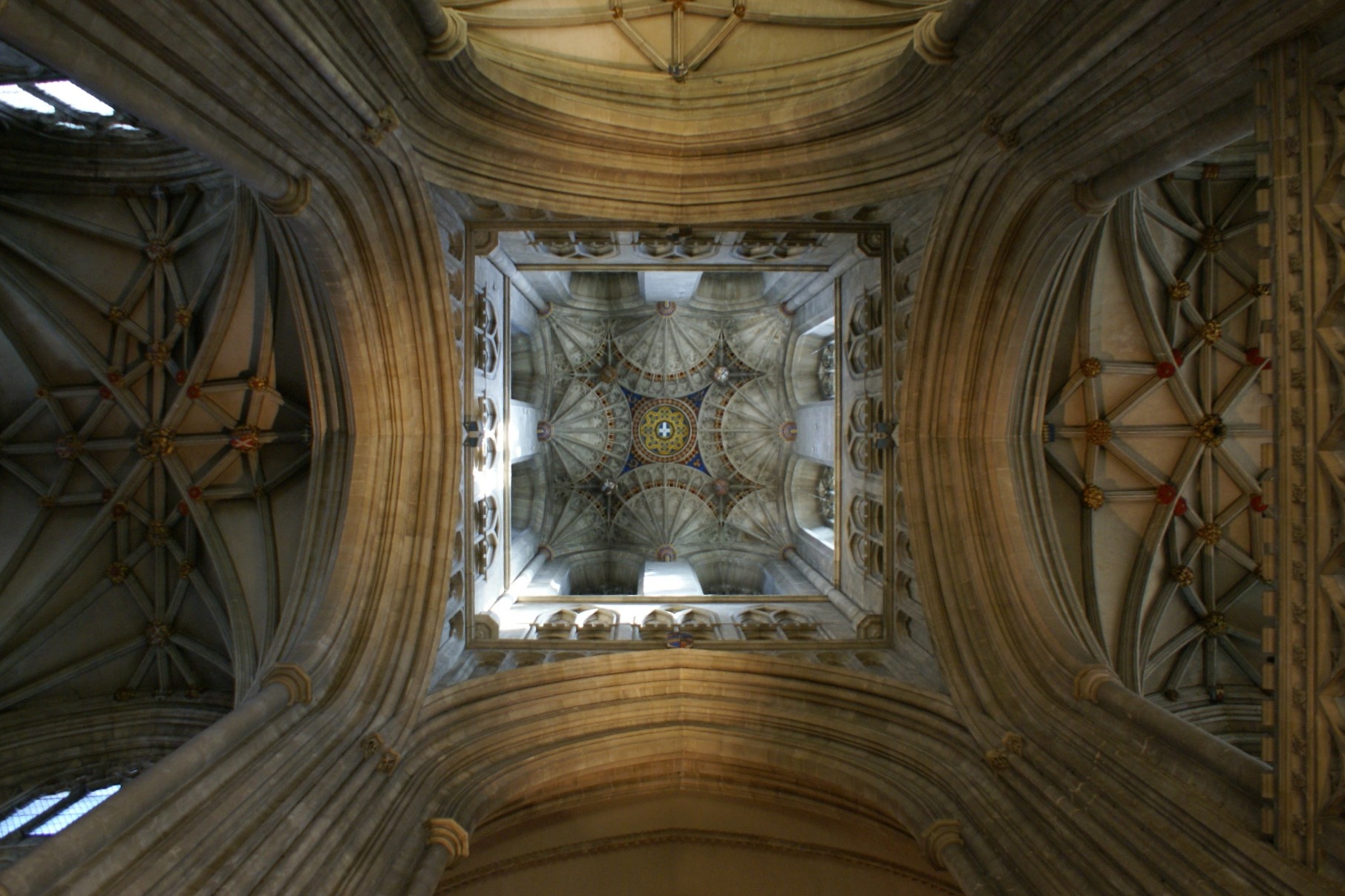 Sunlight highlights the detailed ceiling of the tower over the central crossing in the cathedral.