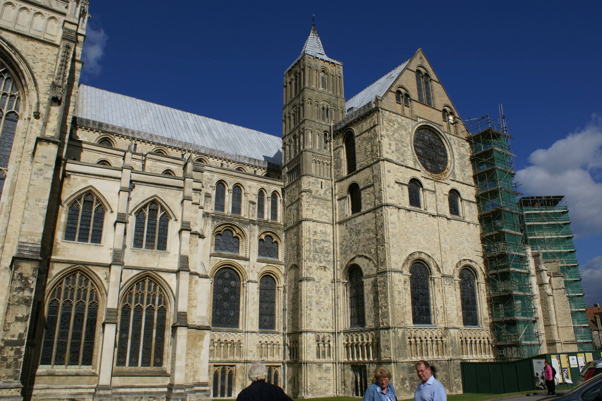 Scaffolding against a portion of a white stone wall near the apse of the cathedral