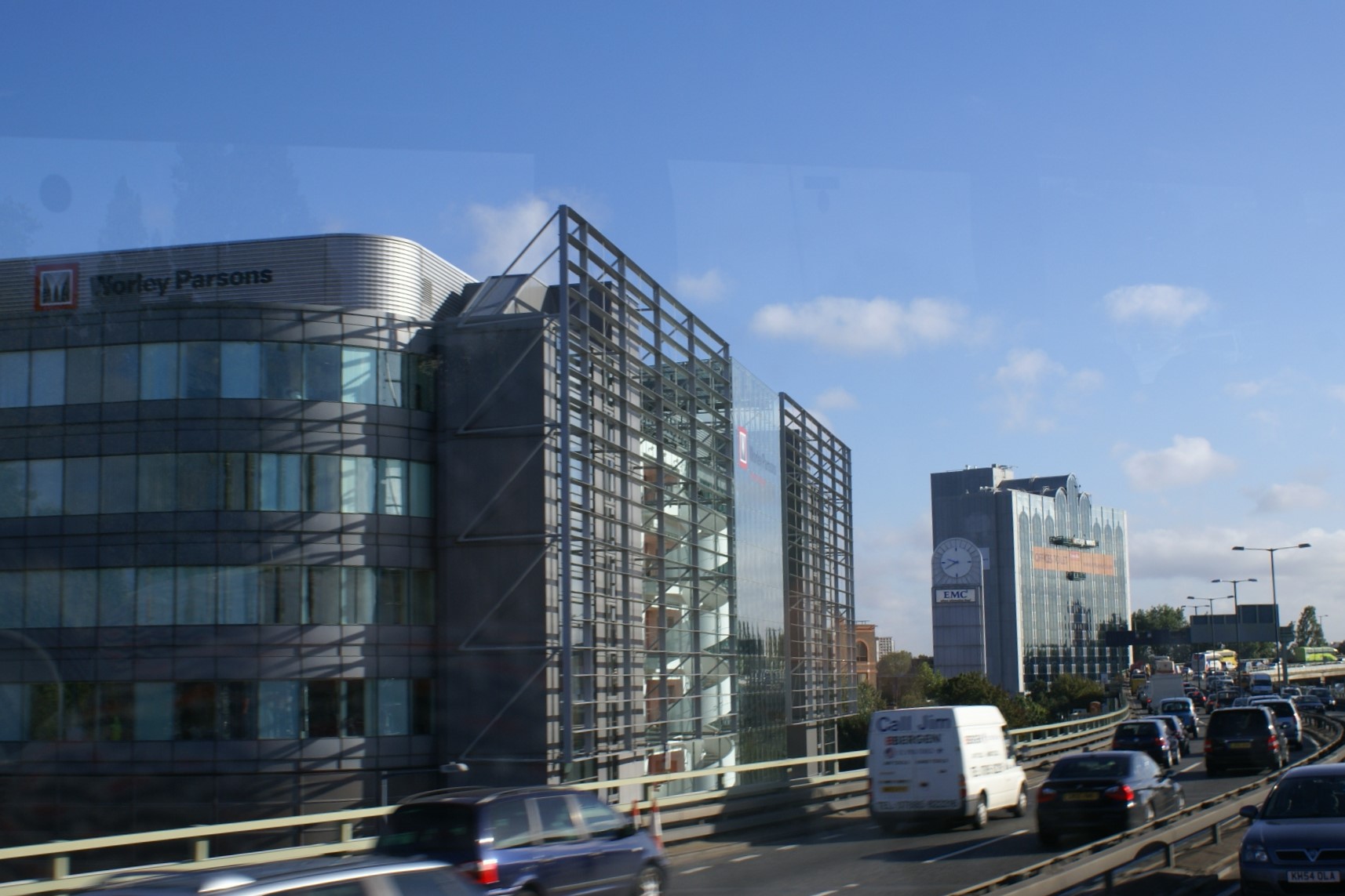 IGlass office buildings line a highway full of cars