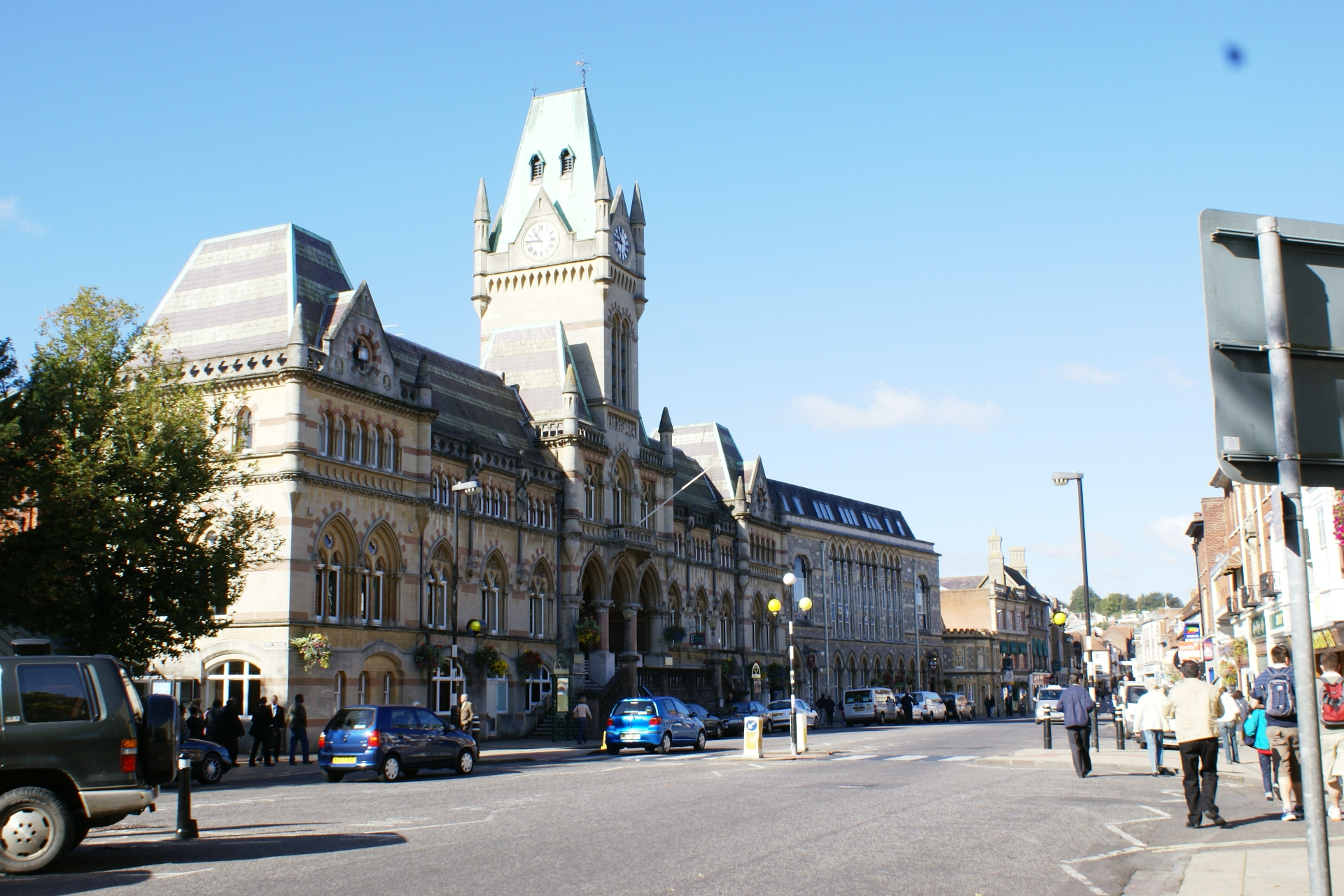 Large stone three-story building with mansard roofs and a central tower