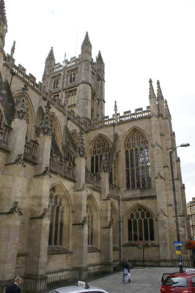 Tan stone walls with gothic design and large glass windows