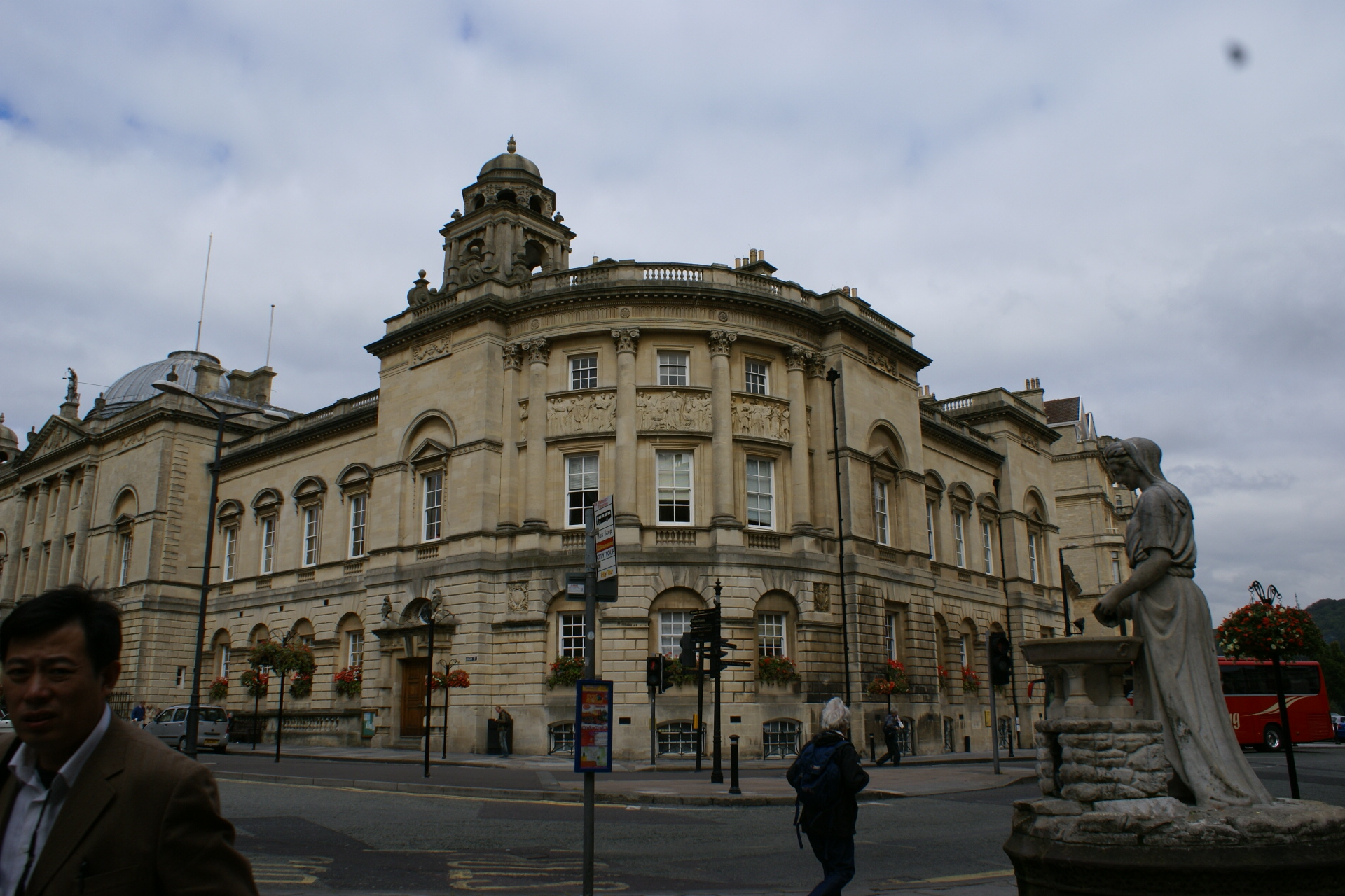 A large Mediterranean style building wraps the corner of a street
