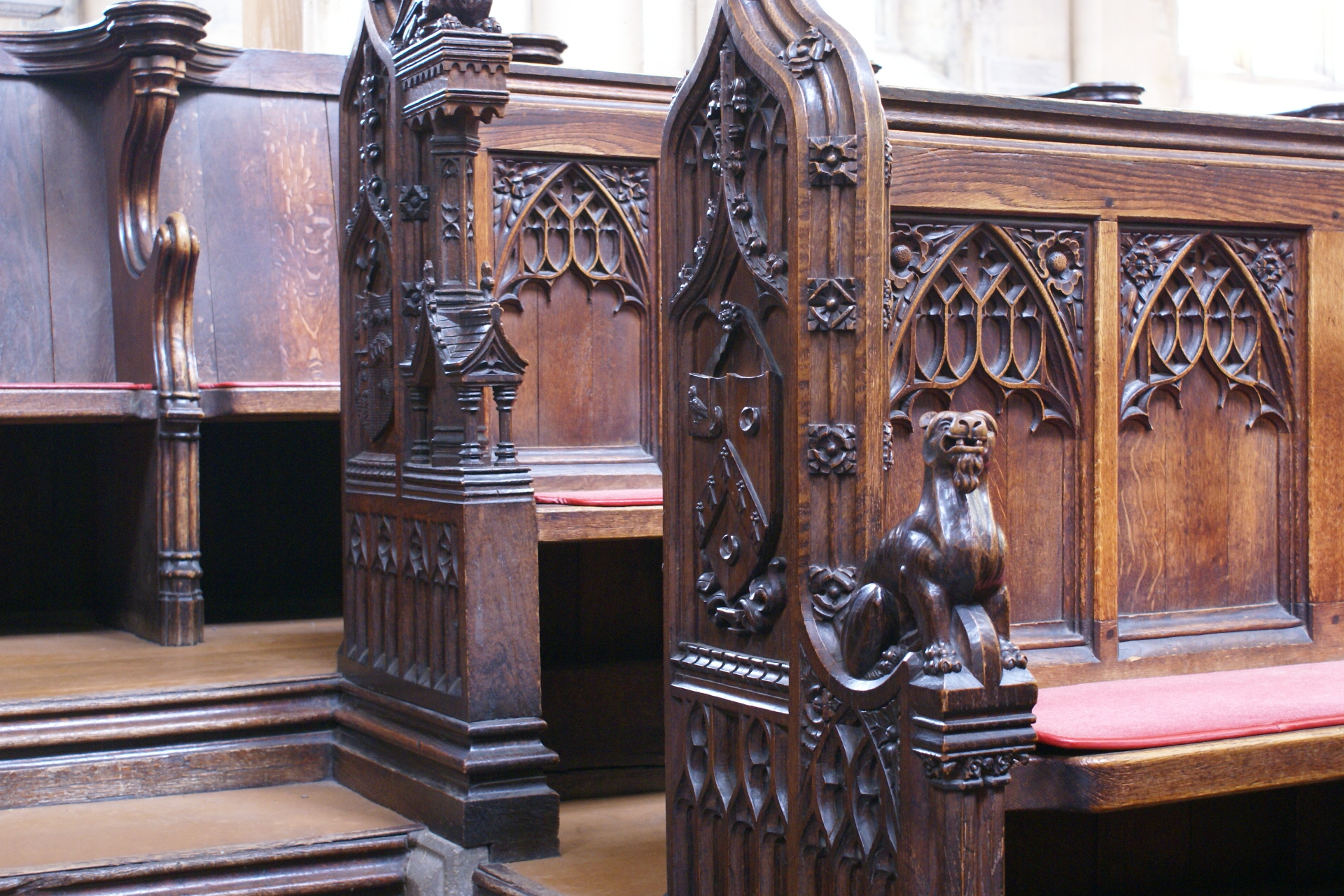 Closeup photo of wood carvings on wood benches