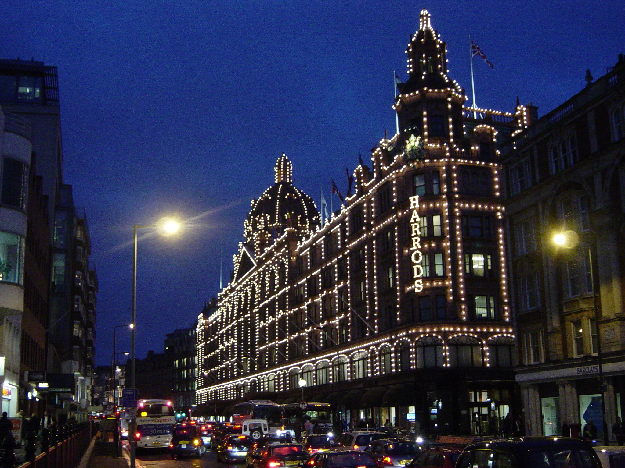 Exterior of a building with string lights highlighting its façade in the late evening