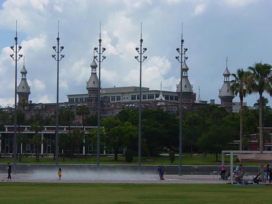 A building with zinc onion shaped domes rises above the trees