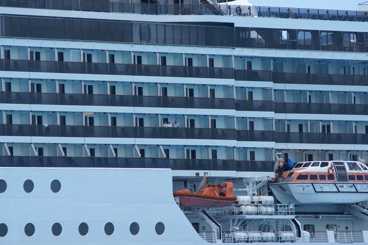 The side of a large cruise ships with decks of balconies