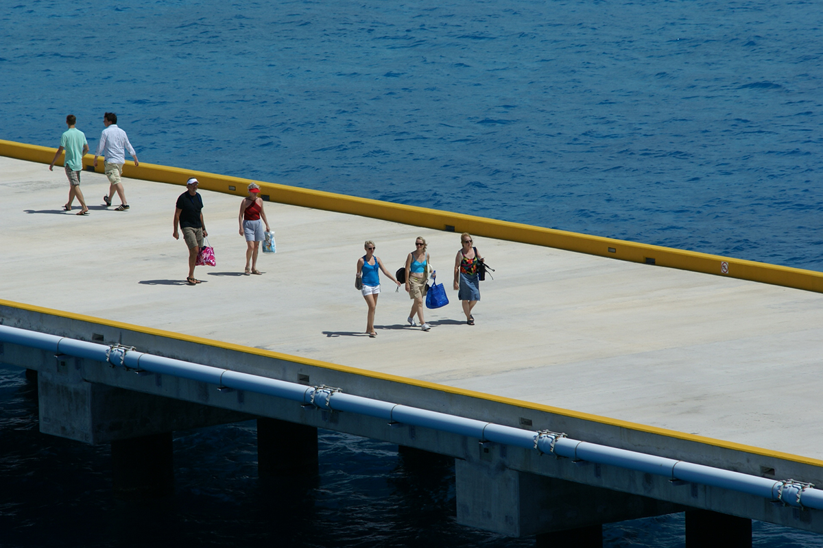 Cindy, Cheri, and Gayle walk down a concrete pier