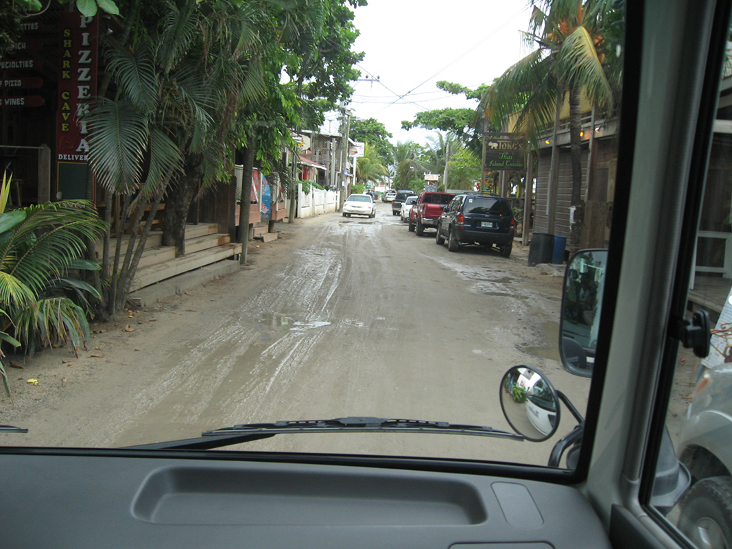 A mud-covered road runs between buildings