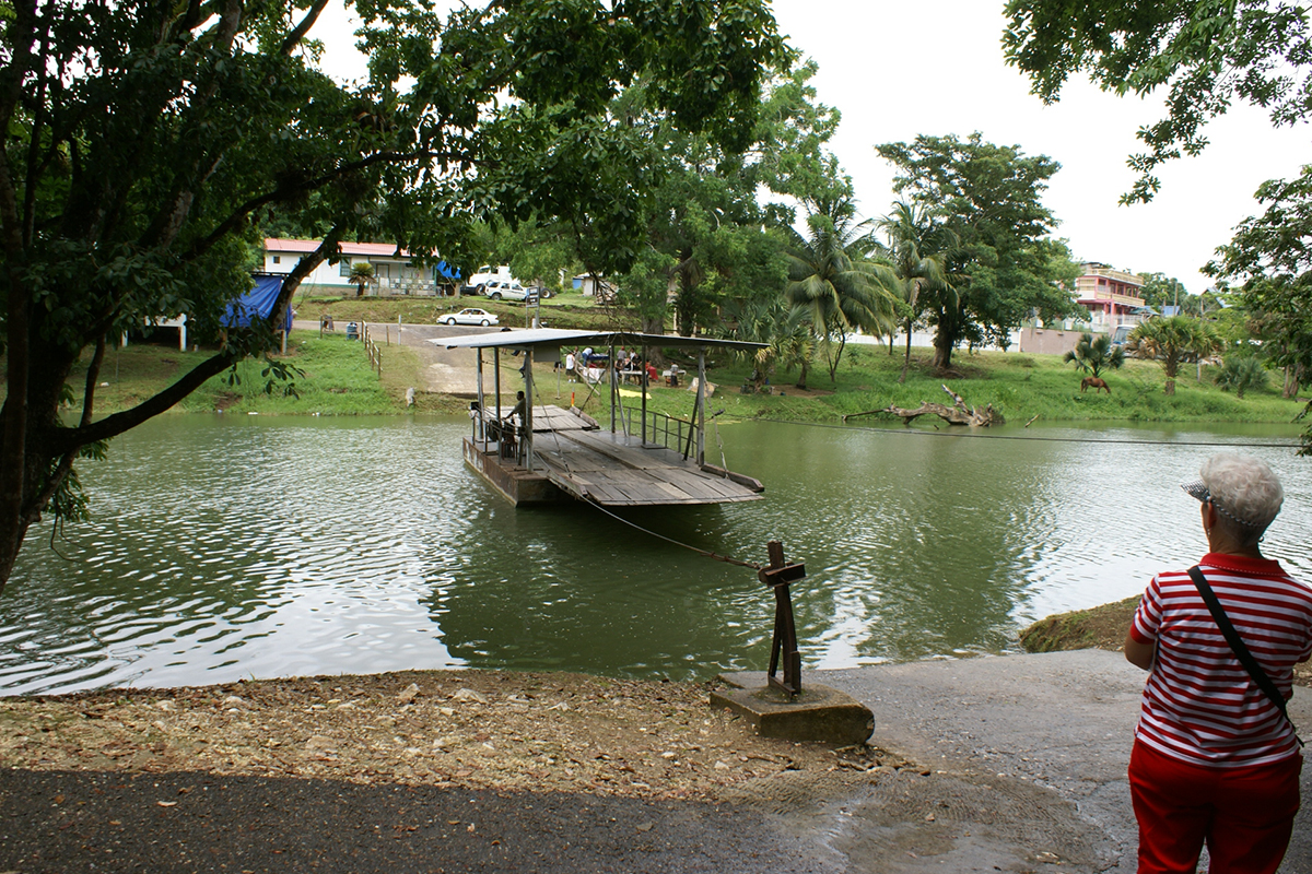 A ferry attached to a cable spanning a river