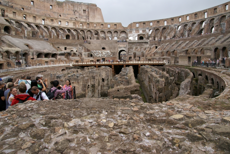 An oval of sloped walls raising 50 feet in the air surrounds a pit where divider walls used to support a false floor and allow for different activities on the floor of the colosseum