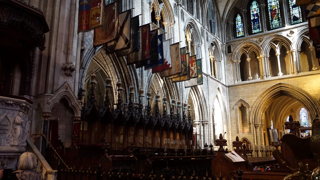 Pointed arches on two levels support arched openings for windows allowing light into the interior of a large church