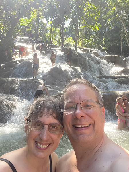 James and Julie with cascading waterfalls in the distance