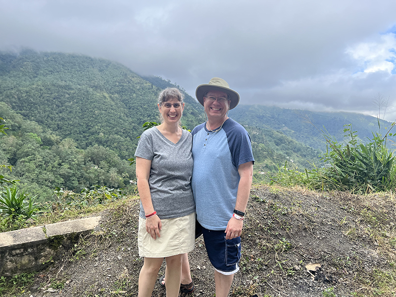 James and Julie with tree covered mountains beyond