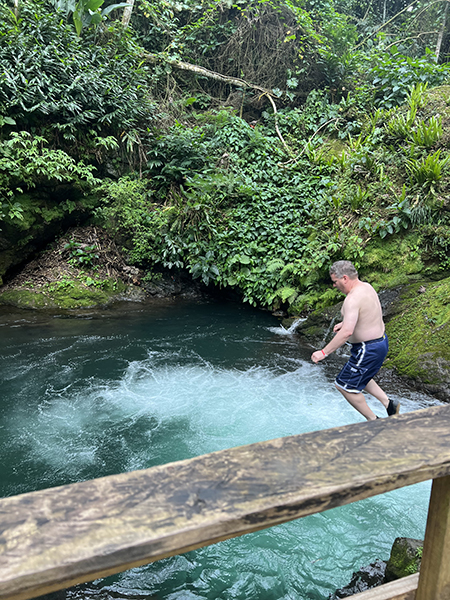 James in midair after jumping off the rocks into the whirlpool
