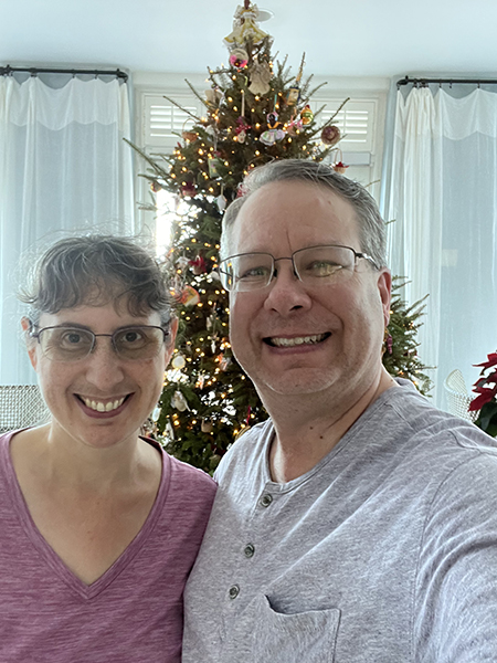 James and Julie in front of the Christmas tree in the resort lobby