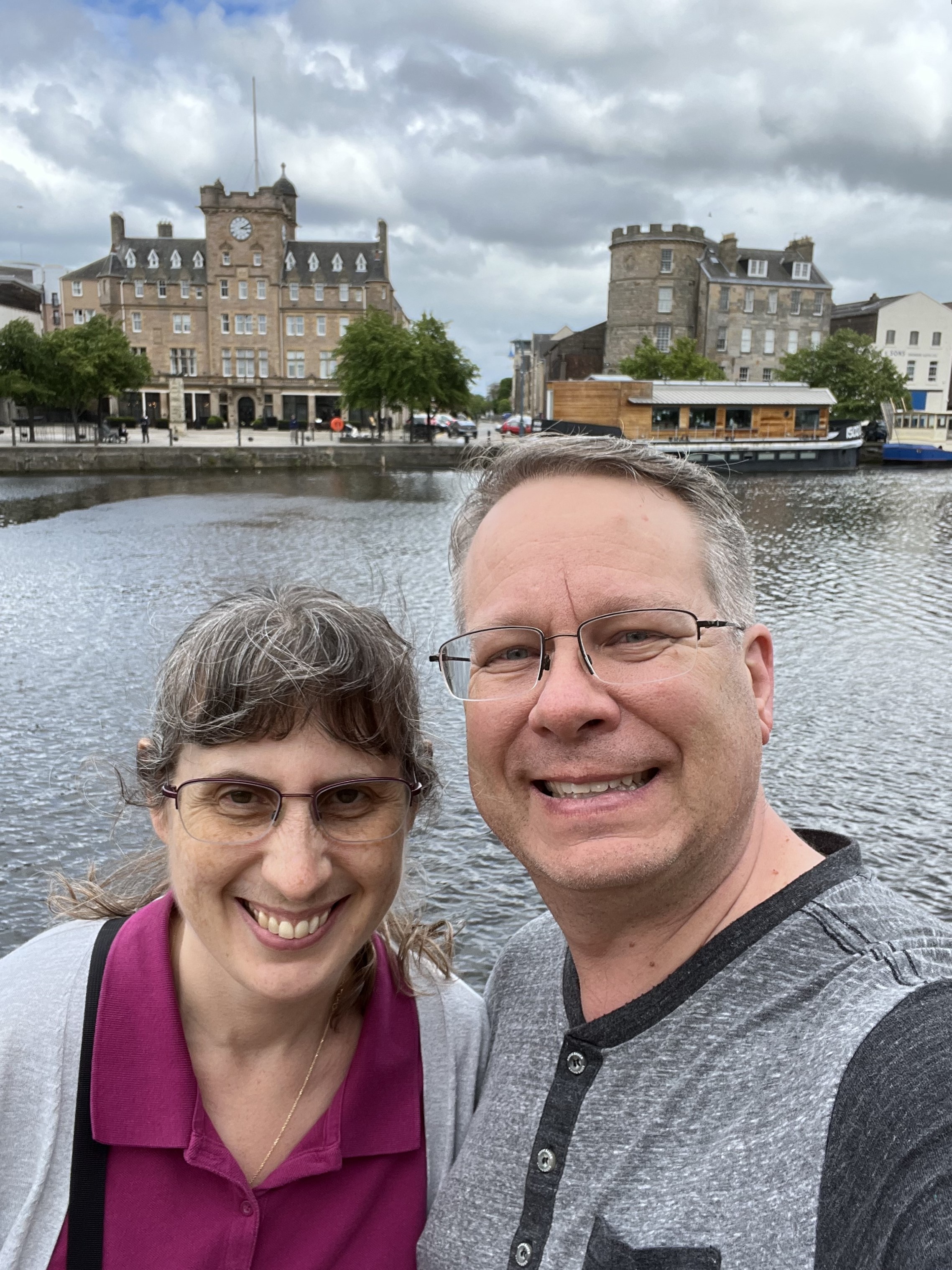 James and Julie in front of waterway and old buildings