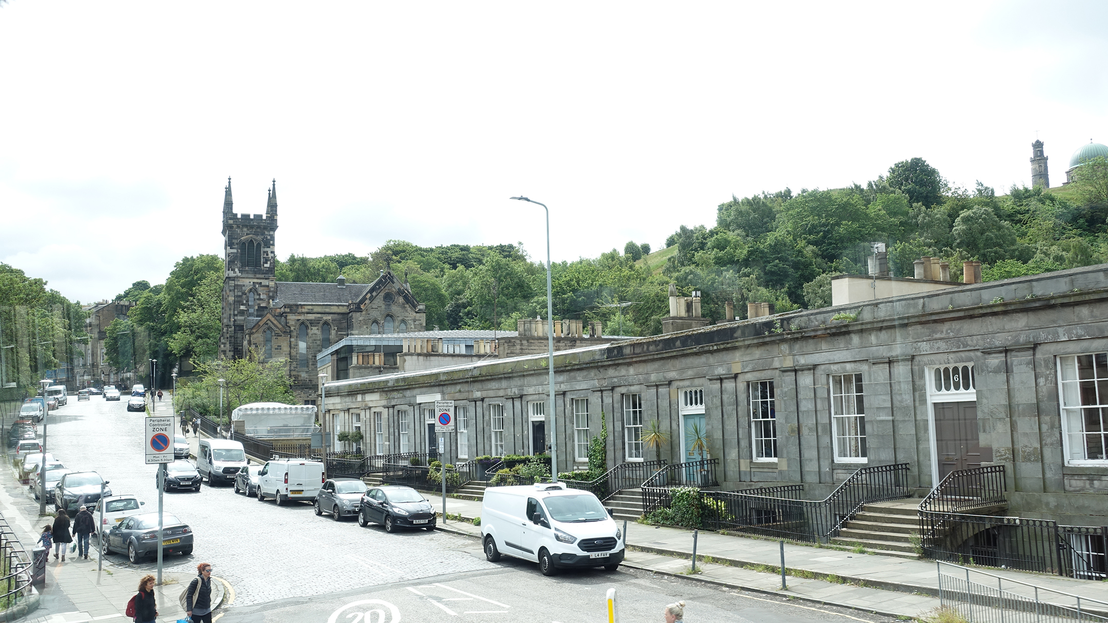 Streetscape with church and hillside in distance