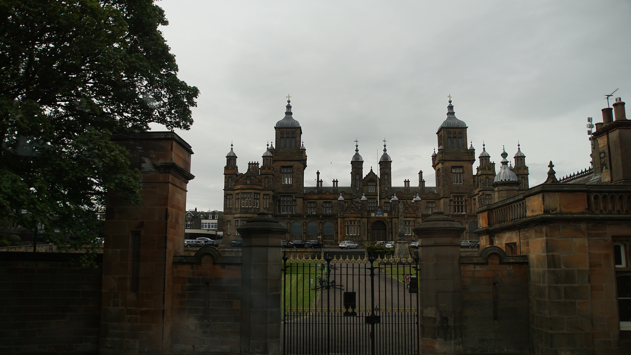 Ornate limestone building behind gated entry