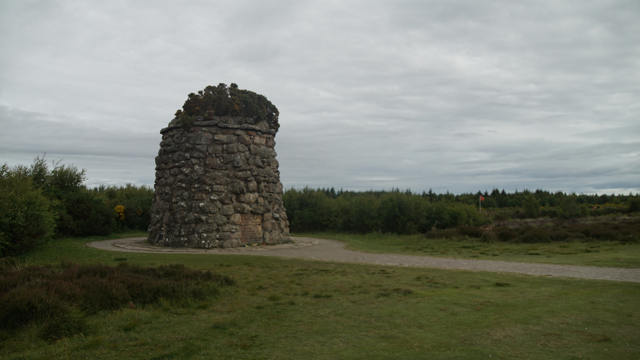 Large round stone marker in field of grass