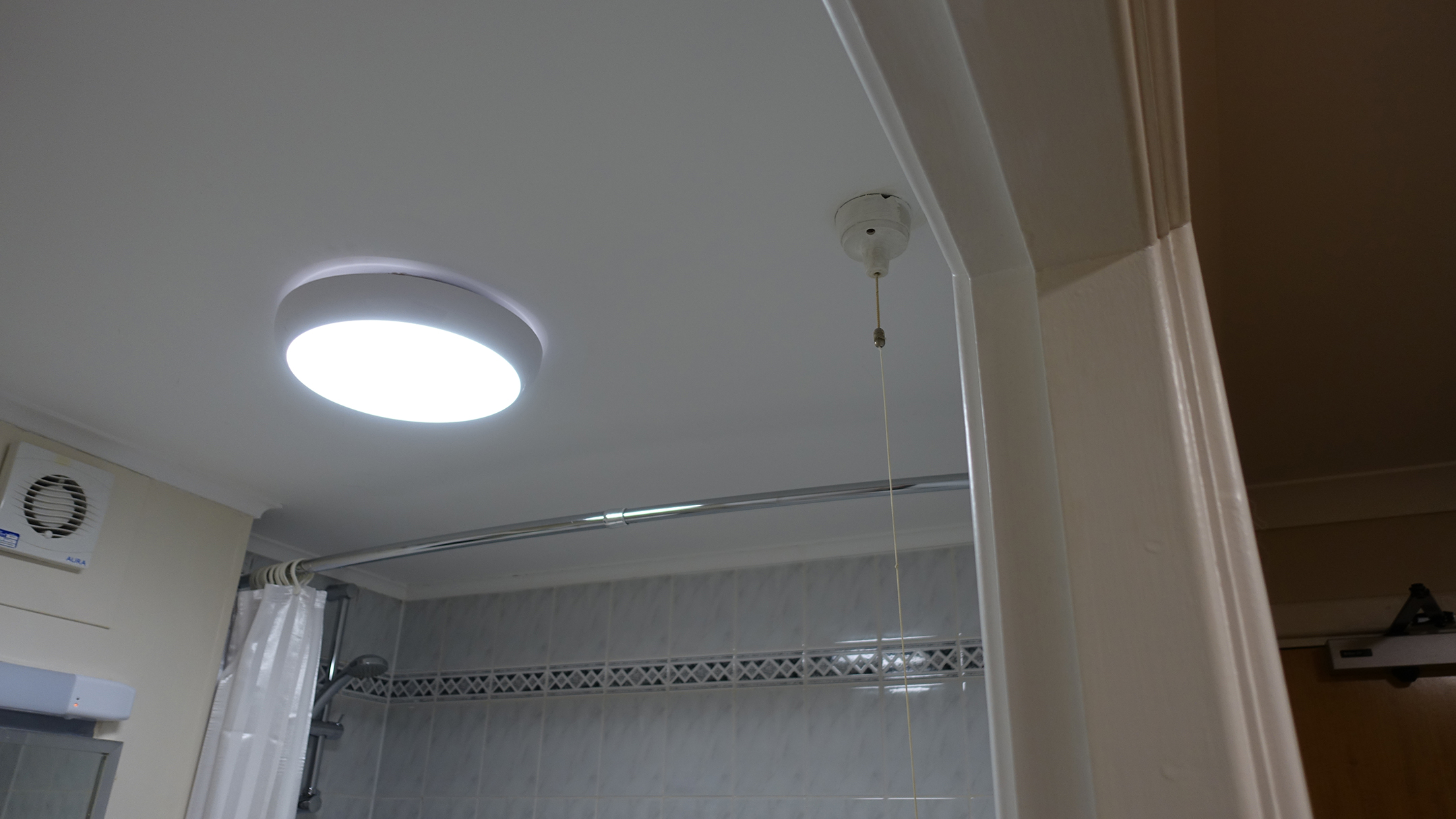 Bathroom ceiling with pull-string for switch