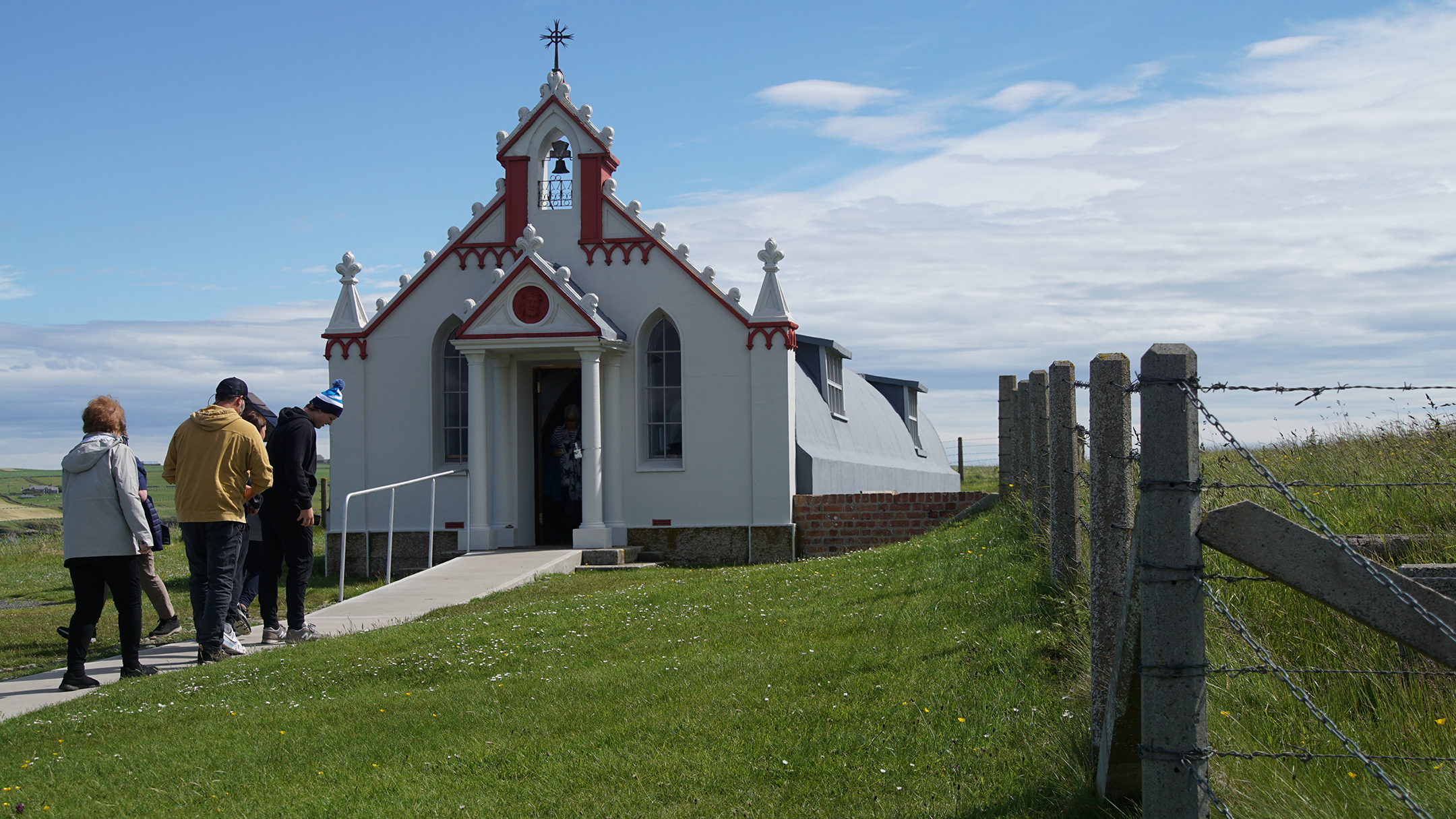 Ornate entry to plain gray curved top structure