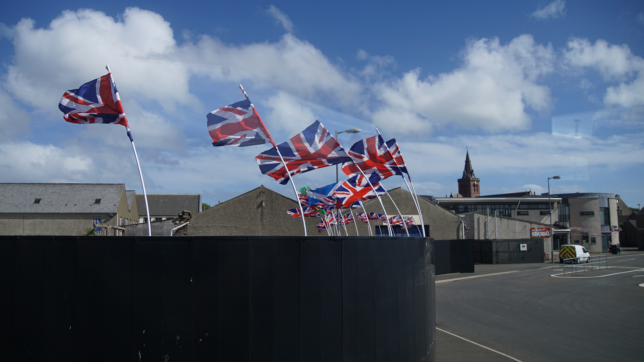 British flags whipping in the wind on bent flag poles