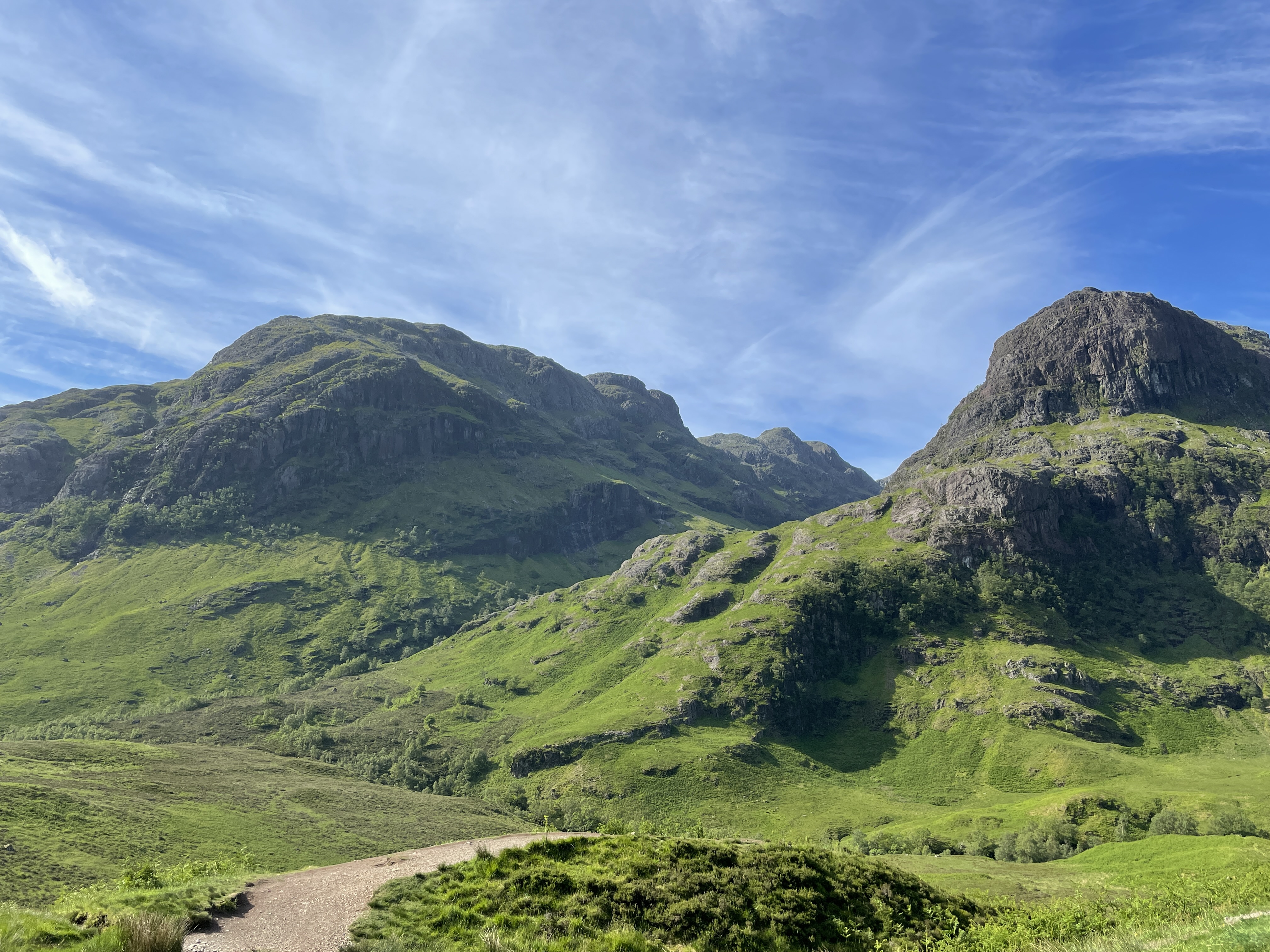 Two rocky peaks with green grassy sides