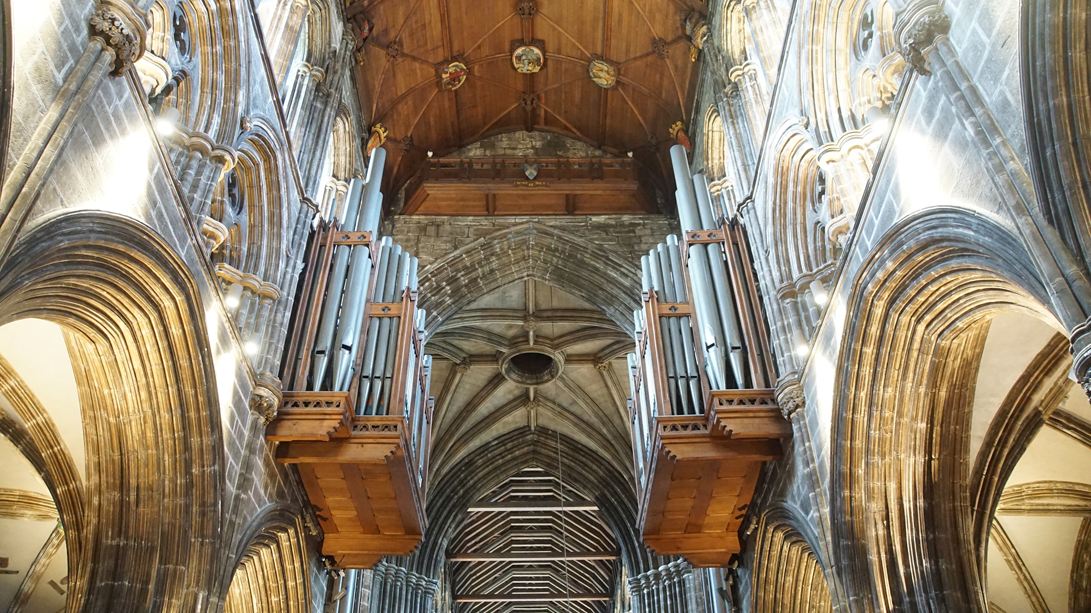 Stone walls support two sets of pipes for an organ