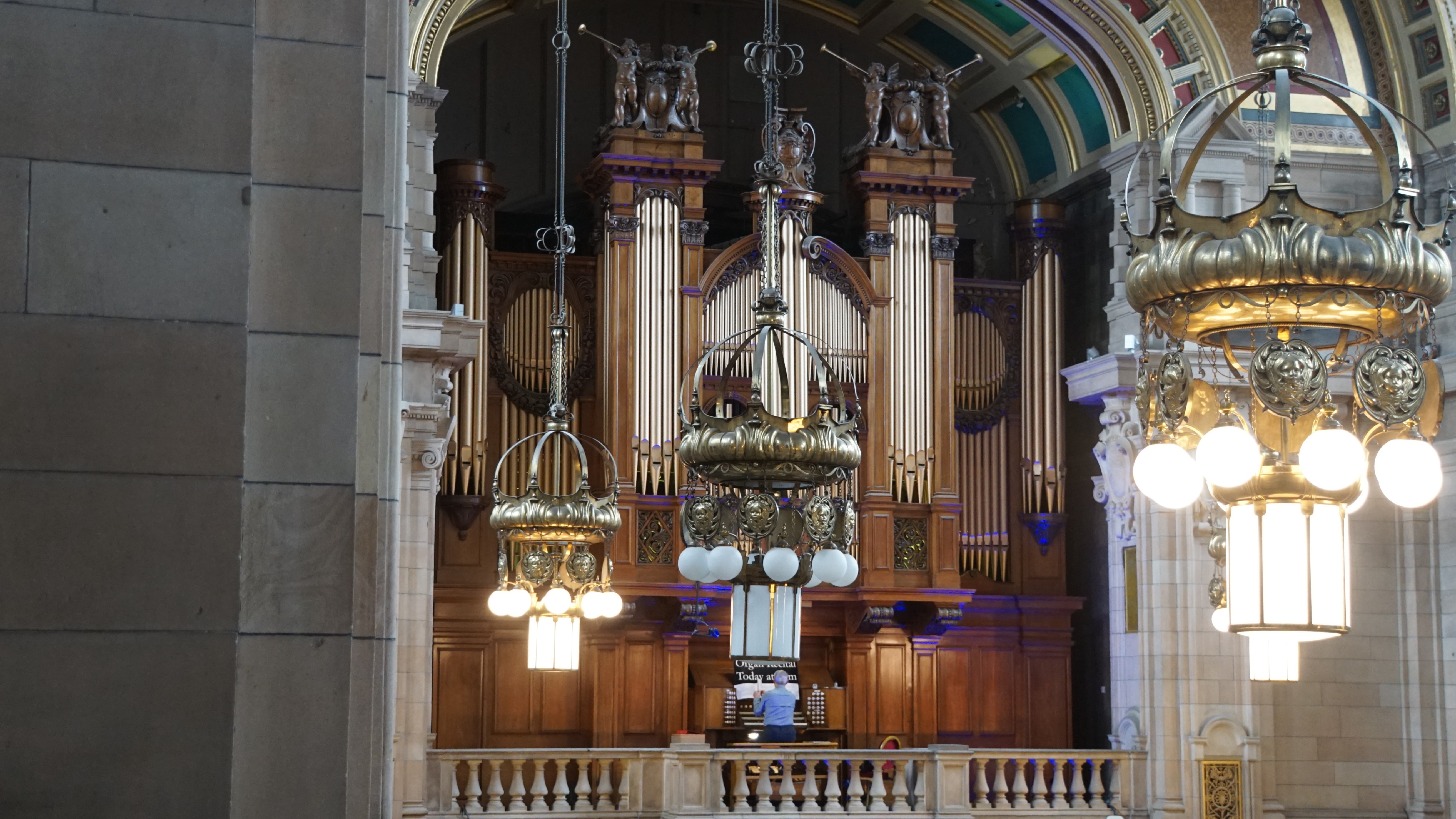 Man playing pipe organ