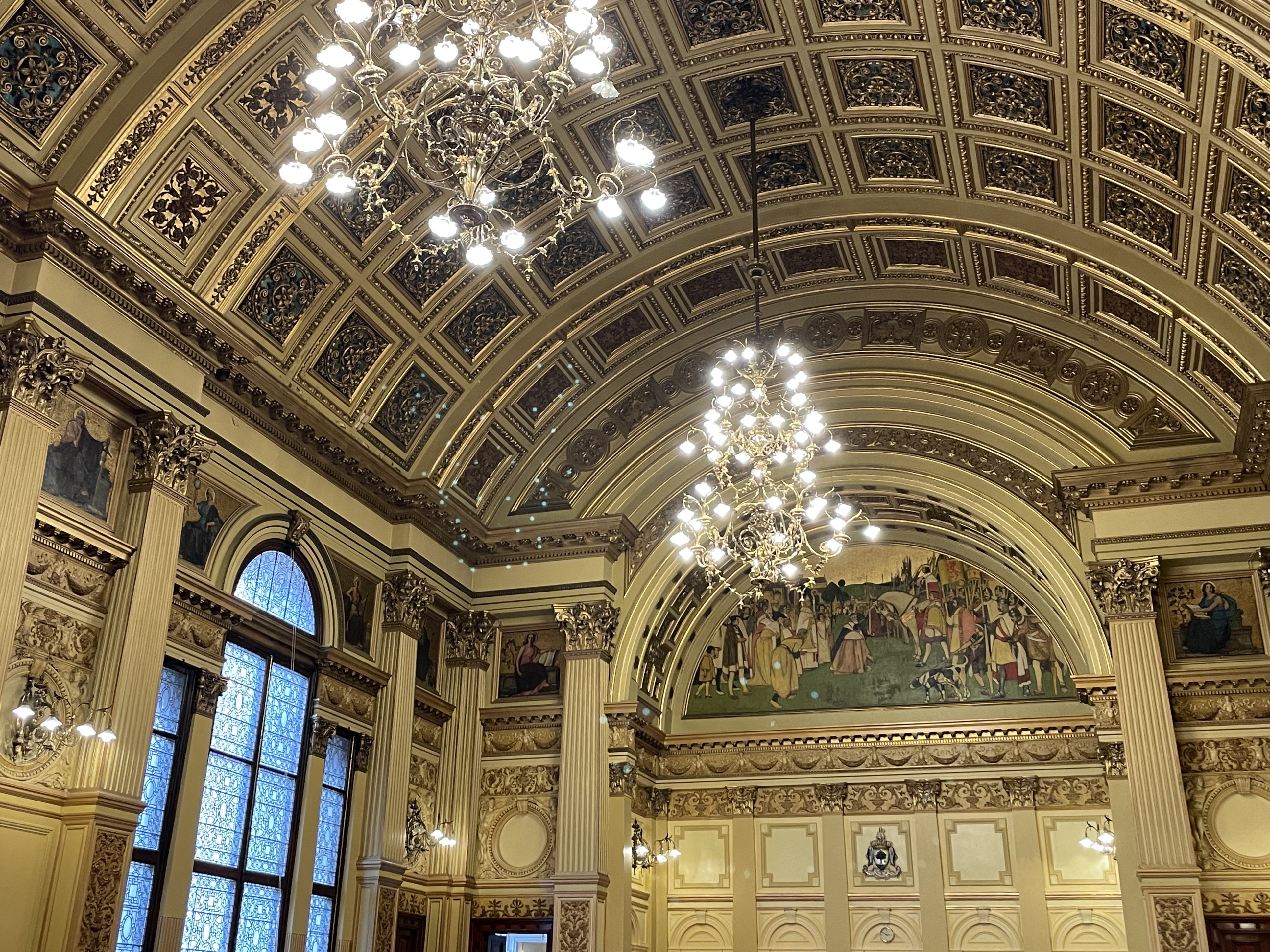 Ornate curved ceiling with highly detailed chandeliers
