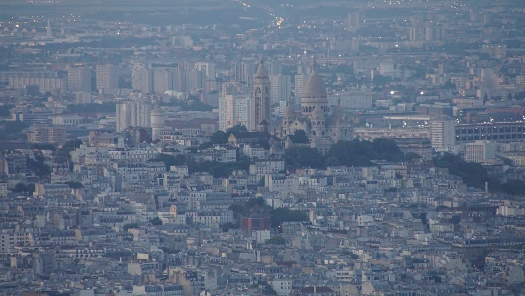 The white Basilica Sacre Cœur sits atop the hill of the neighborhood of Montmarte