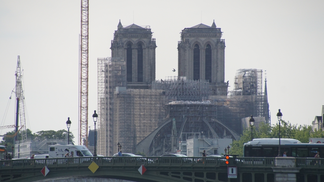 The bell towers of a cathedral extend above scaffolding surround the end of the building