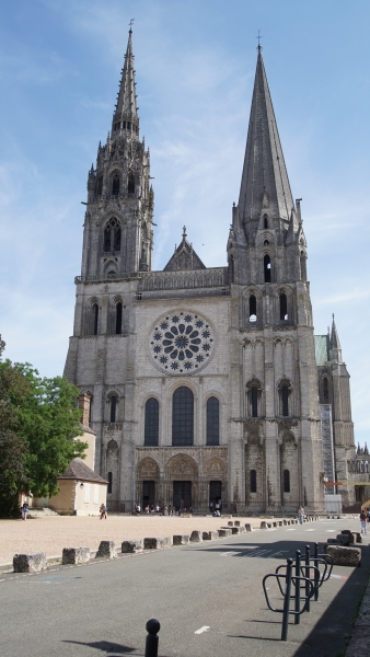 Tall spires extend from bell towers on either side of a stone façade of a Cathedral
