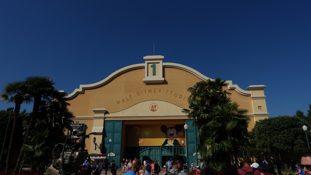 A large tan building with Walt Disney Studios and the number one over the entry