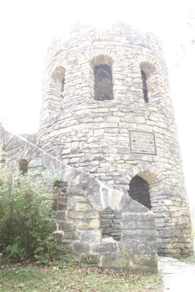 A two-story stone memorial tower with stairs and arched openings