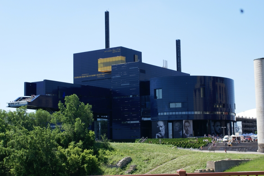 A black metal panel building with large areas of glass