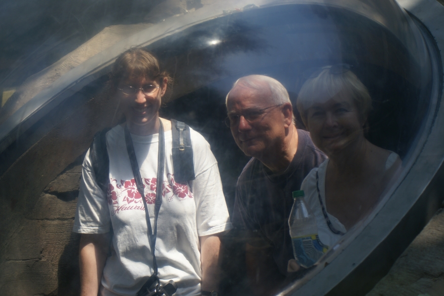 Julie, Jim, and Gayle look at through a plastic bubble across an animal enclosure