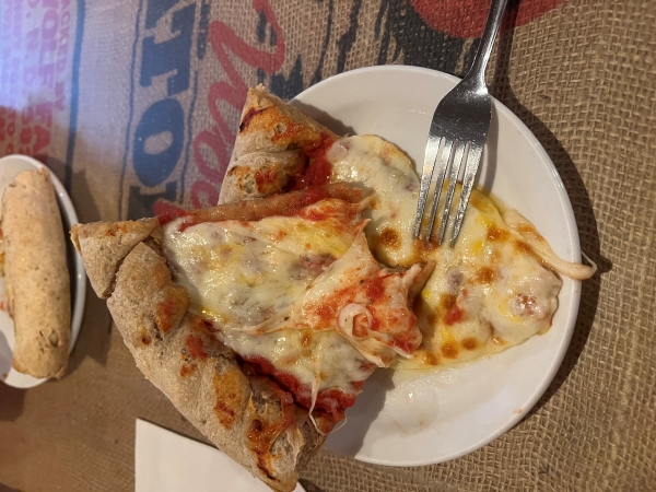 Two slices of pizza with thick wheat crust